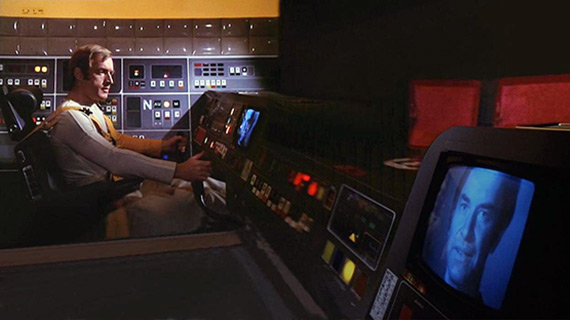 Alan Carter (Nick Tate) from Space: 1999 speaks with Commander Koenig in the Eagle cockpit.